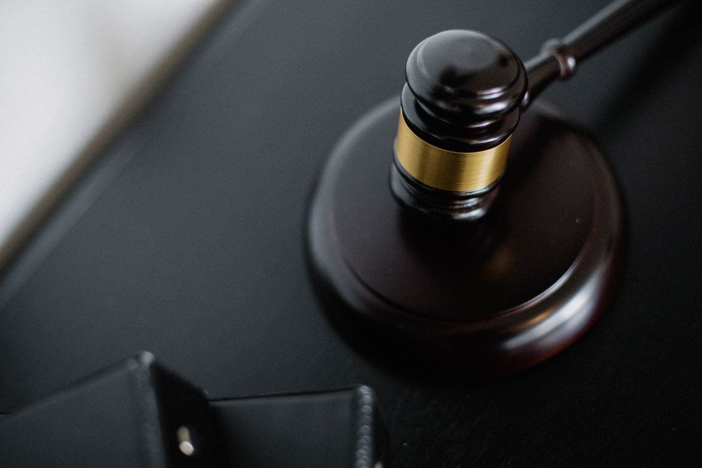 A judge's gavel on a courtroom desk