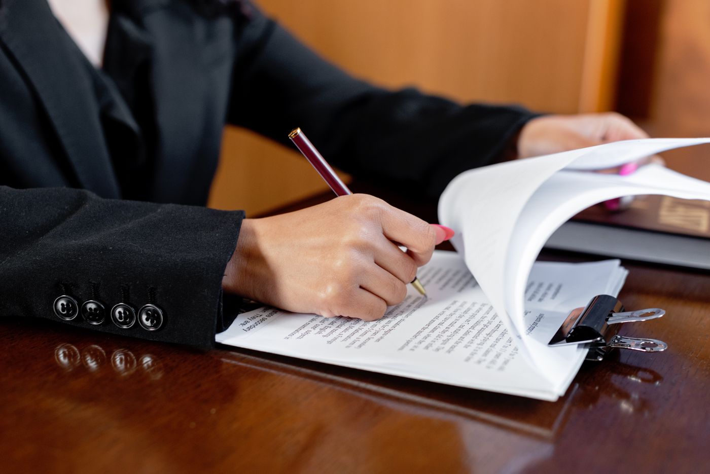 An officer signing a printed document at a desk