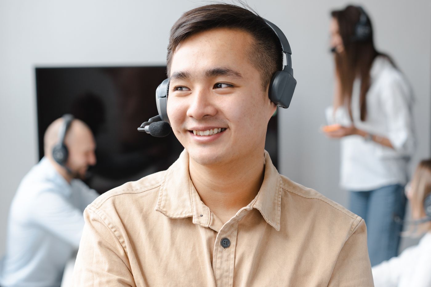 A member of the support team on a call at his desk